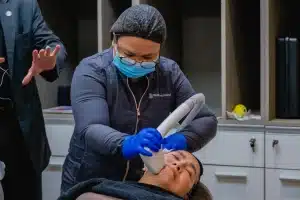 A clinical staff doing Sofwave treatment